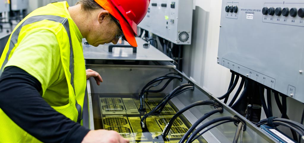 U.S. technician working on data center equipment, which commonly contains minerals such as titanium, tin, and copper. 